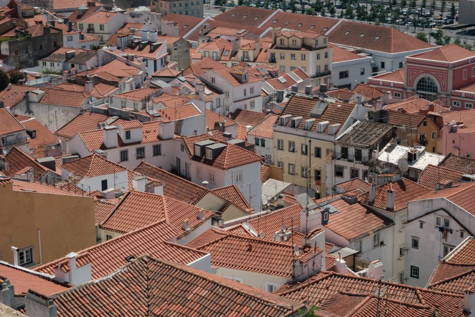 A captivating aerial view of red tiled roofs in Lisbon, showcasing traditional Portuguese architecture.