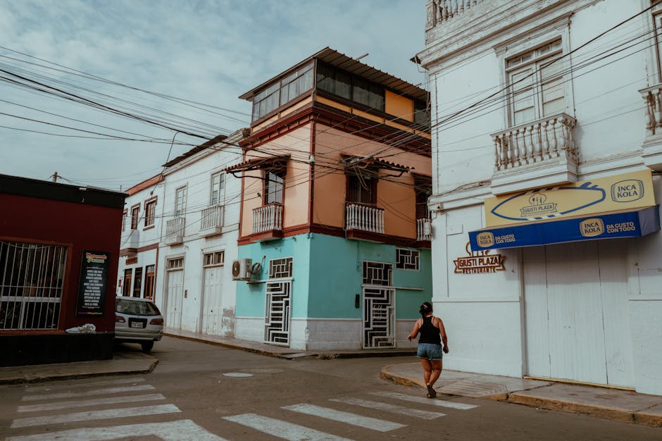 Explore the colorful streets of Pacasmayo, Peru, featuring vibrant buildings and local life.