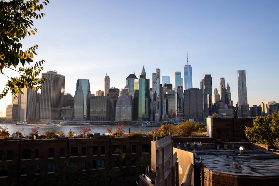 Capture of the iconic New York City skyline during sunset with vibrant sky and silhouetted skyscrapers.