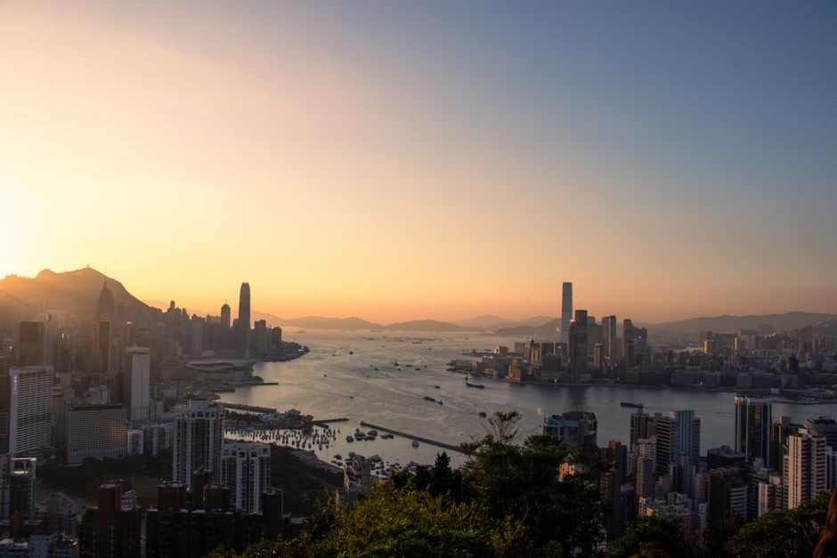 A breathtaking view of Hong Kong's skyline and harbor at sunset, capturing urban beauty.