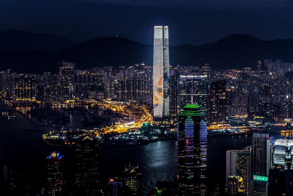 Dazzling night view of Kowloon's skyline with illuminated skyscrapers and waterfront.