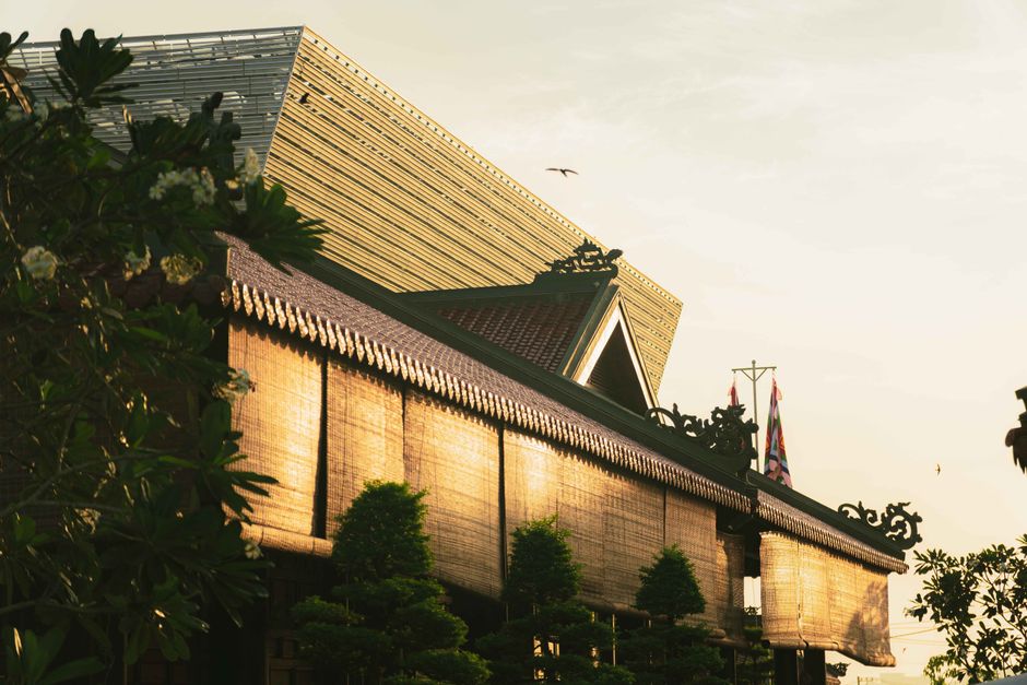 Sunlit traditional Vietnamese building facade in Ho Chi Minh City during sunset.