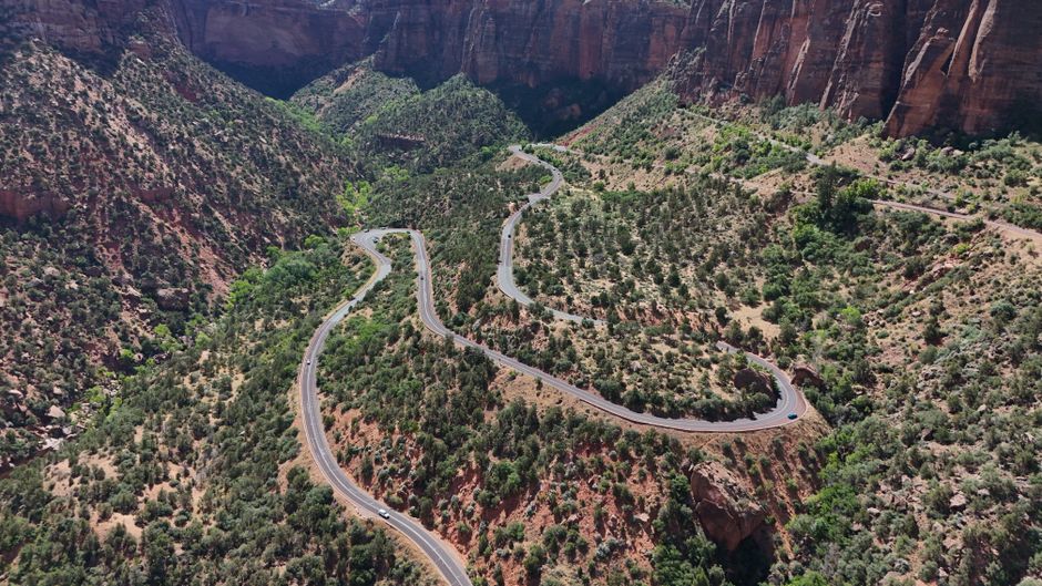 Aerial view of a winding road through the red rock canyons of Zion National Park, Utah.