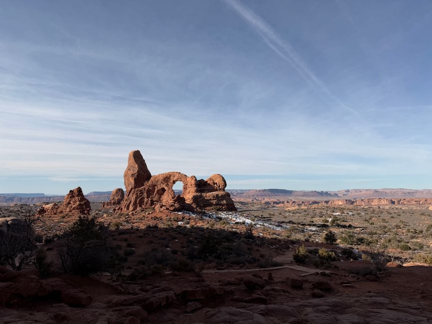 Explore the breathtaking rock formations at Arches National Park under a clear blue sky.
