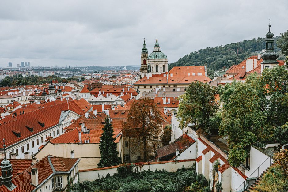 Discover the beauty of Prague with its iconic red rooftops and historic architecture in this stunning cityscape.