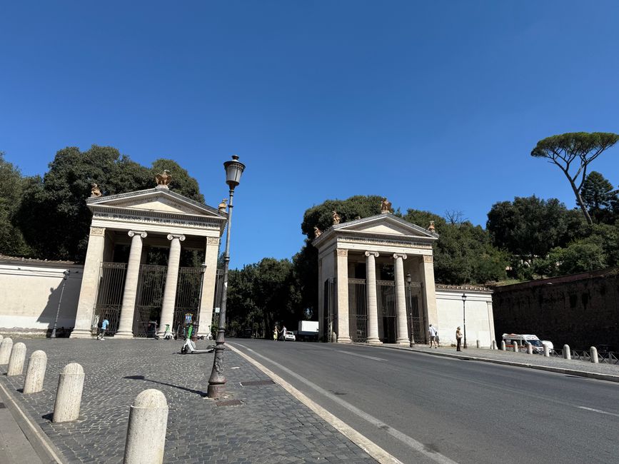 View of the historical Flaminio Gate in Rome, showcasing neoclassical architecture.
